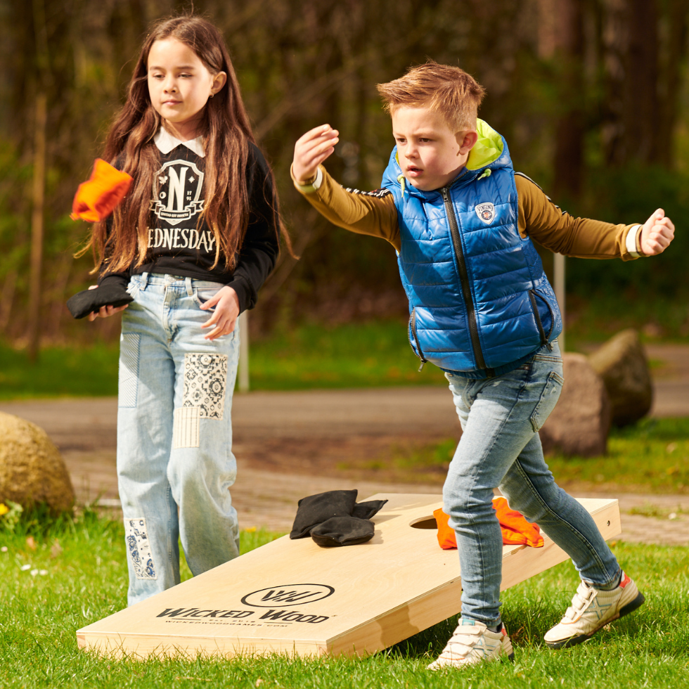 Kids playng cornhole